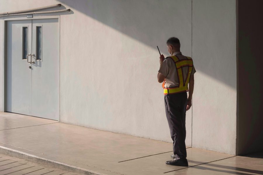 Security guard using walkie talkie while working in parking garage